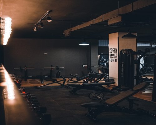 Dark area with multiple power racks and weight plates